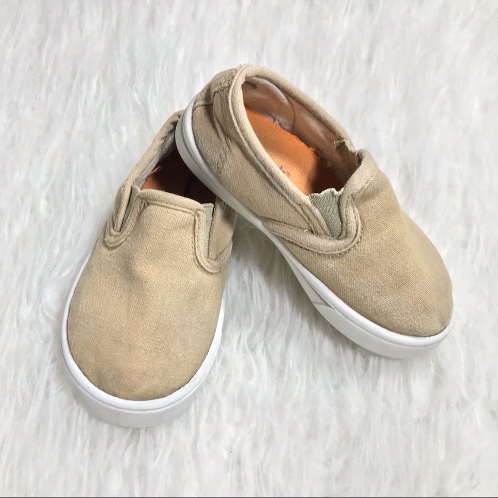 One pair of khaki slip on toddler shoes.